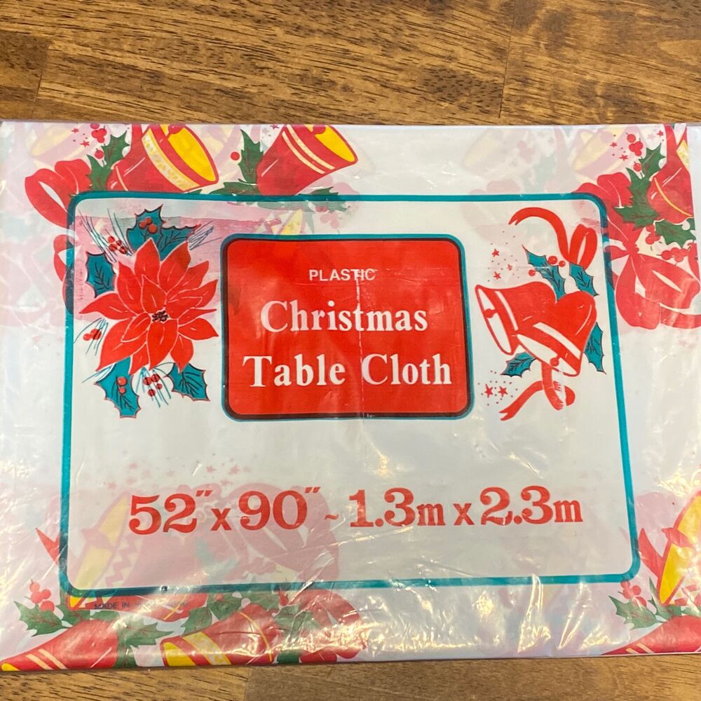 Vintage Christmas Plastic Table Cloth 52”x90” New Old Stock Bells Holly Ribbon